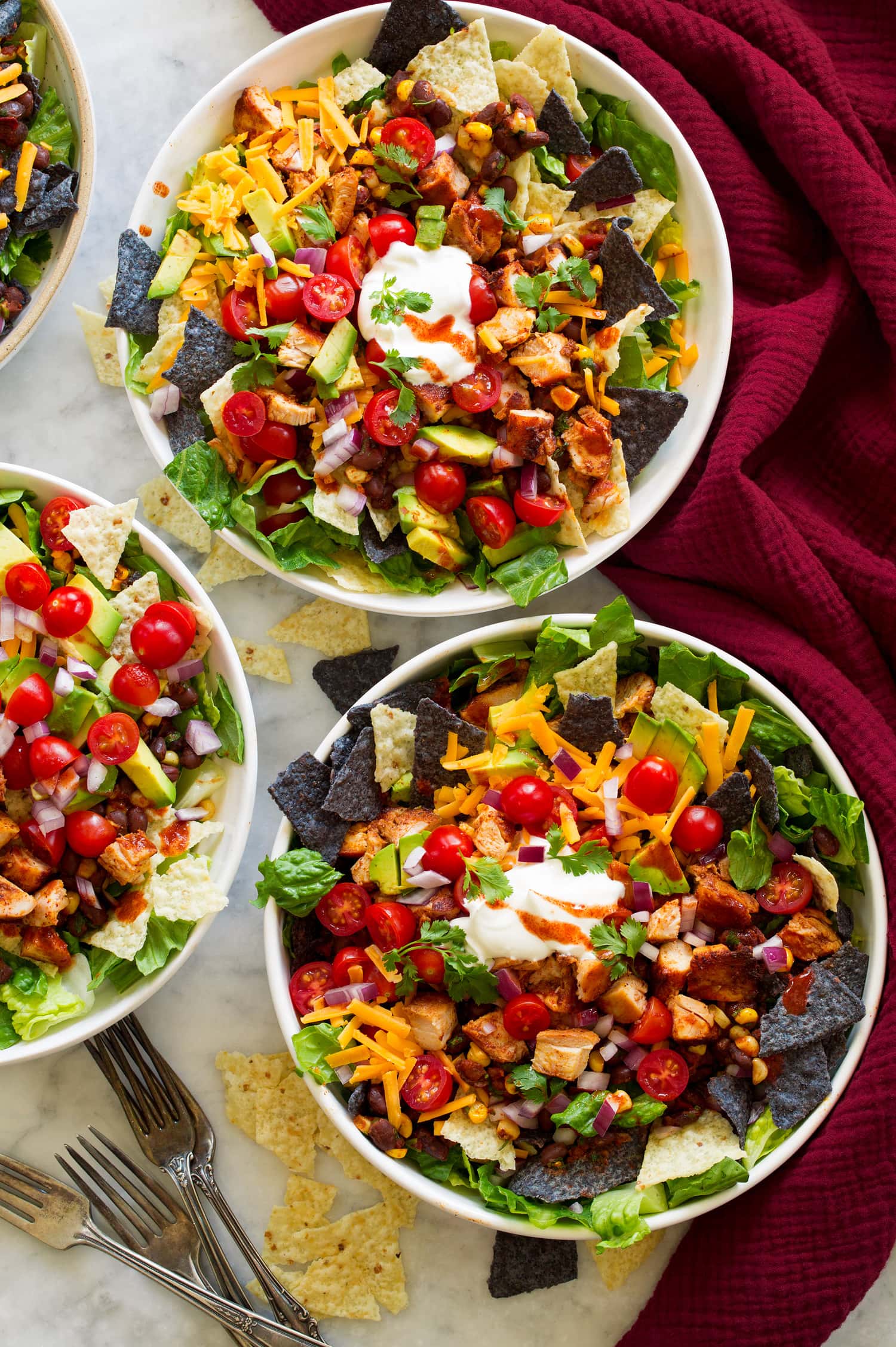 Overhead photo of three chicken taco salad bowls.