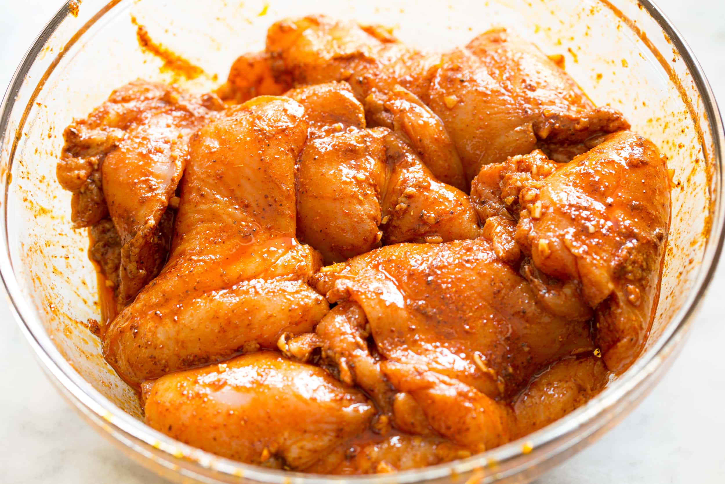 Chicken soaking in Mexican spice marinade.