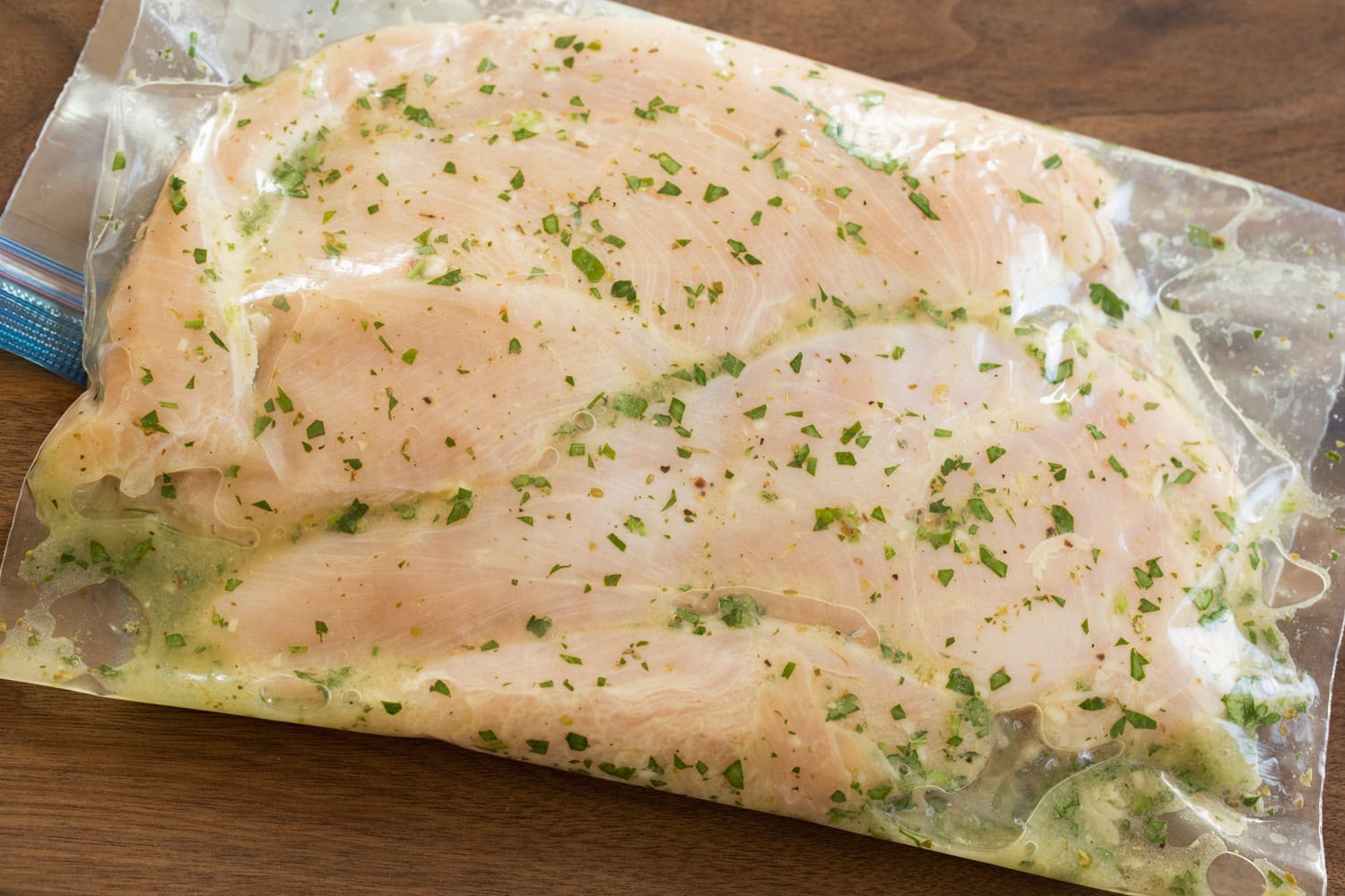 Chicken breasts soaking in marinade.